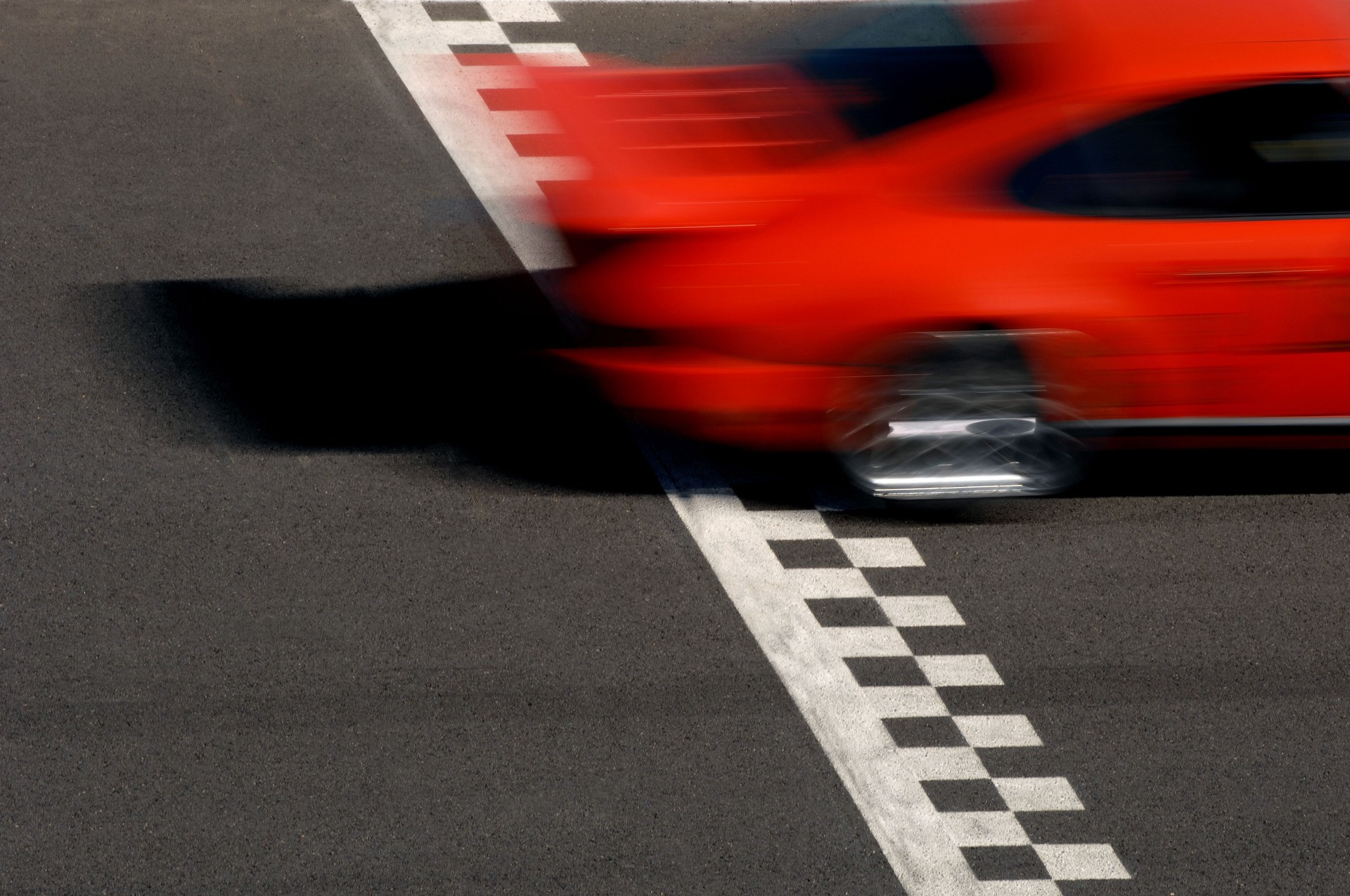 Race Car Crossing Checkered Finish Line